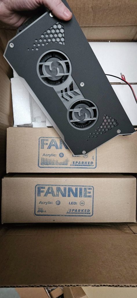 A person is opening a box with a Sparked Innovations Fannie in it.