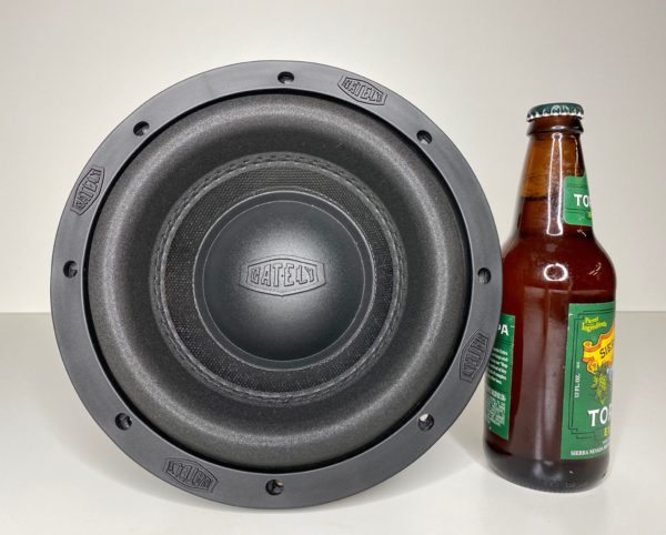 A Gately Audio Alpha 8 Inch Subwoofer next to a bottle of beer.