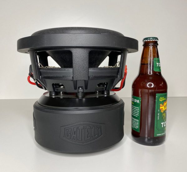 A bottle of beer next to a Gately Audio Relentless 8 Inch Subwoofer.