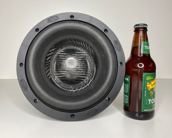 A Gately Audio Relentless 8 Inch Subwoofer next to a bottle of beer.