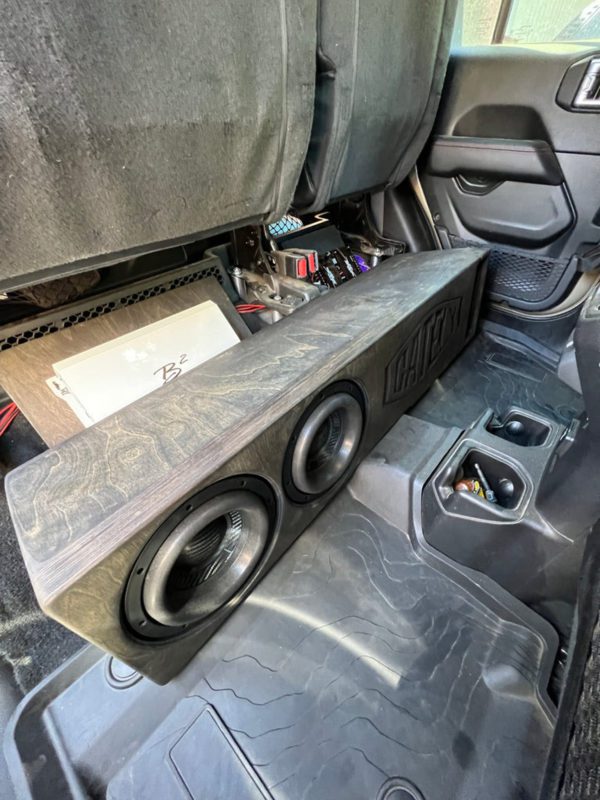 A car with a Gately Audio Perfect Fit Jeep 2x8 Gladiator Underseat in the back seat.