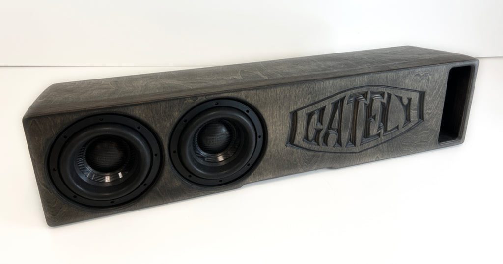A Gately Audio Perfect Fit Jeep 2x8 Gladiator Underseat speaker box with two speakers on it.