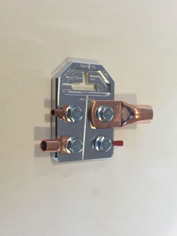 A copper plate with two Sky High Car Audio Flat 4 Spot Battery Terminals (Pair) on it.