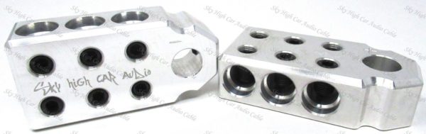 A pair of Sky High Car Audio SAE 1/0 6 Input Set Screw Battery Terminals (Pair) with holes in them.