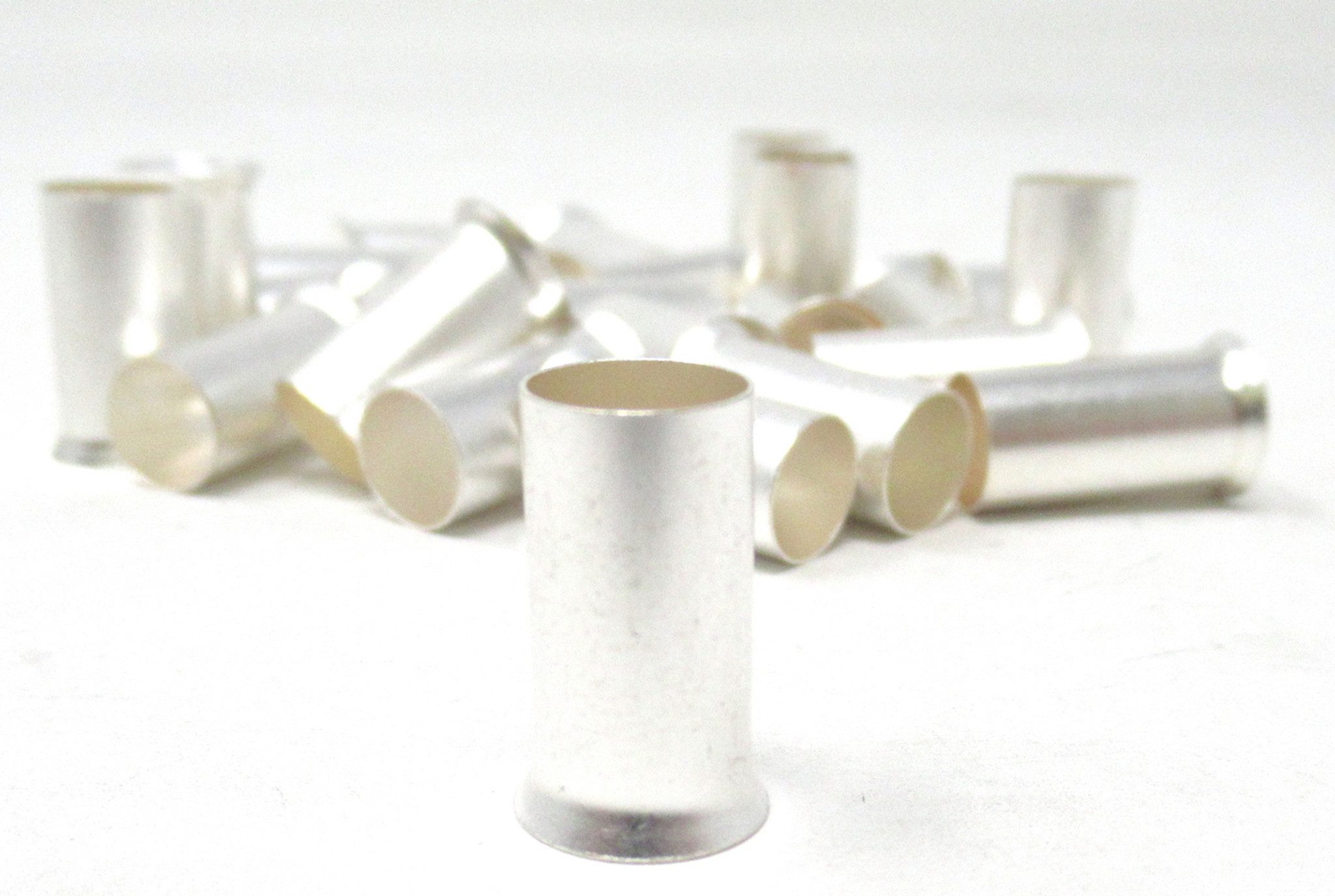 A group of 4 GA Wire Ferrules - Copper Tinned 25pk on a white surface.