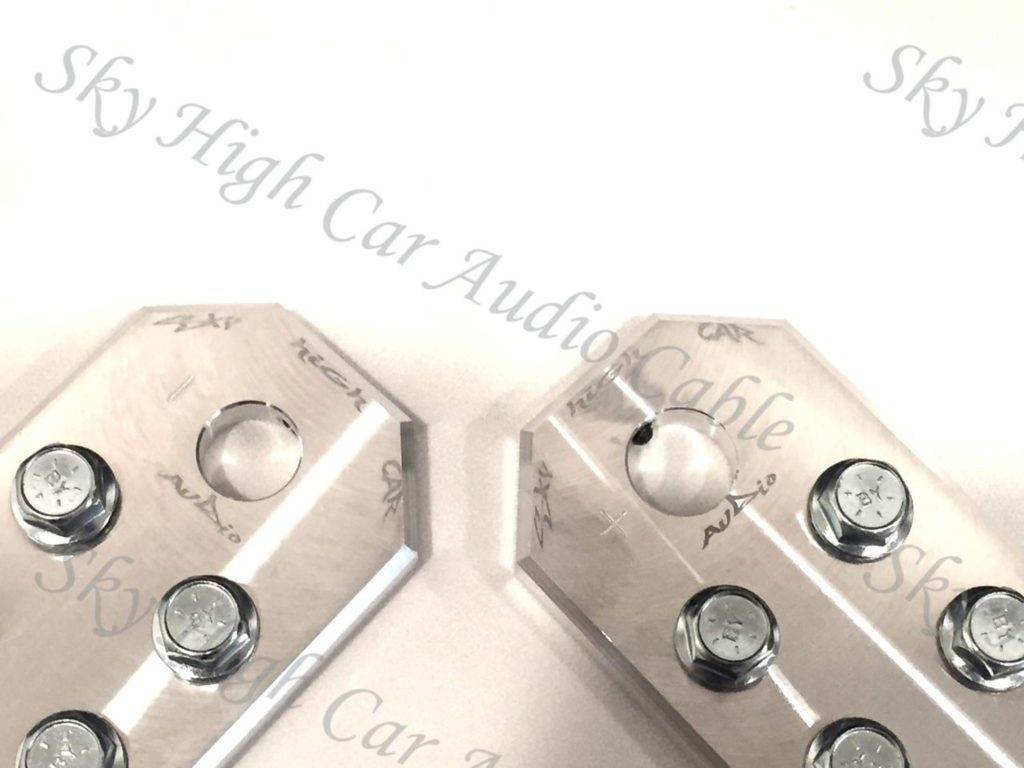 A pair of Sky High Car Audio SAE Flat 6 Spot Battery Terminals on a white surface.