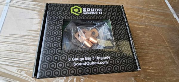 A box with the Soundqubed 1/0 Big 3 - Underhood Electrical Wiring Upgrade Kit inside of it.