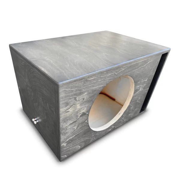 A gray Adire Audio Performance Series subwoofer enclosure with a hole in it.