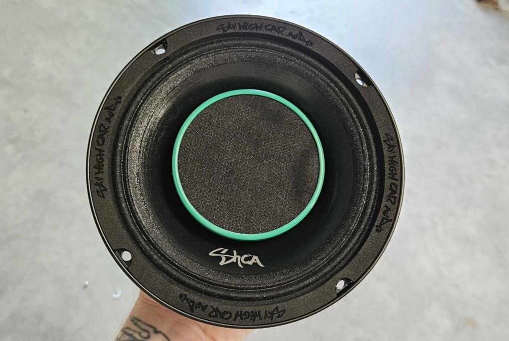 A person holding a SHCA Pro Audio HD6.4E 6.5 inch Hybrid Midrange Coaxial Speaker 450 Watts 4 ohm (Single) on hand