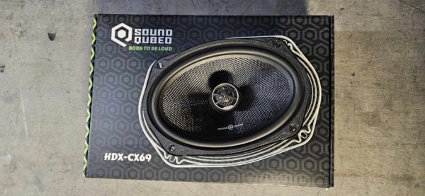 An Open Box - Soundqubed HDX-CX69 6x9 Inch Coaxial Speakers with a car speaker in it.