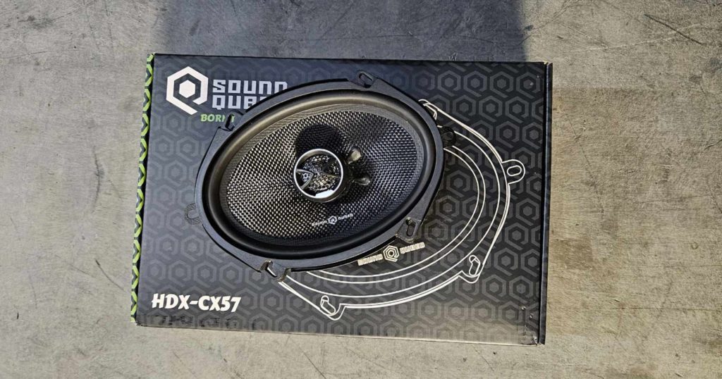 A pair of Open Box - Soundubed HDX-CX57 5x7 Coaxial Speakers on a concrete floor.